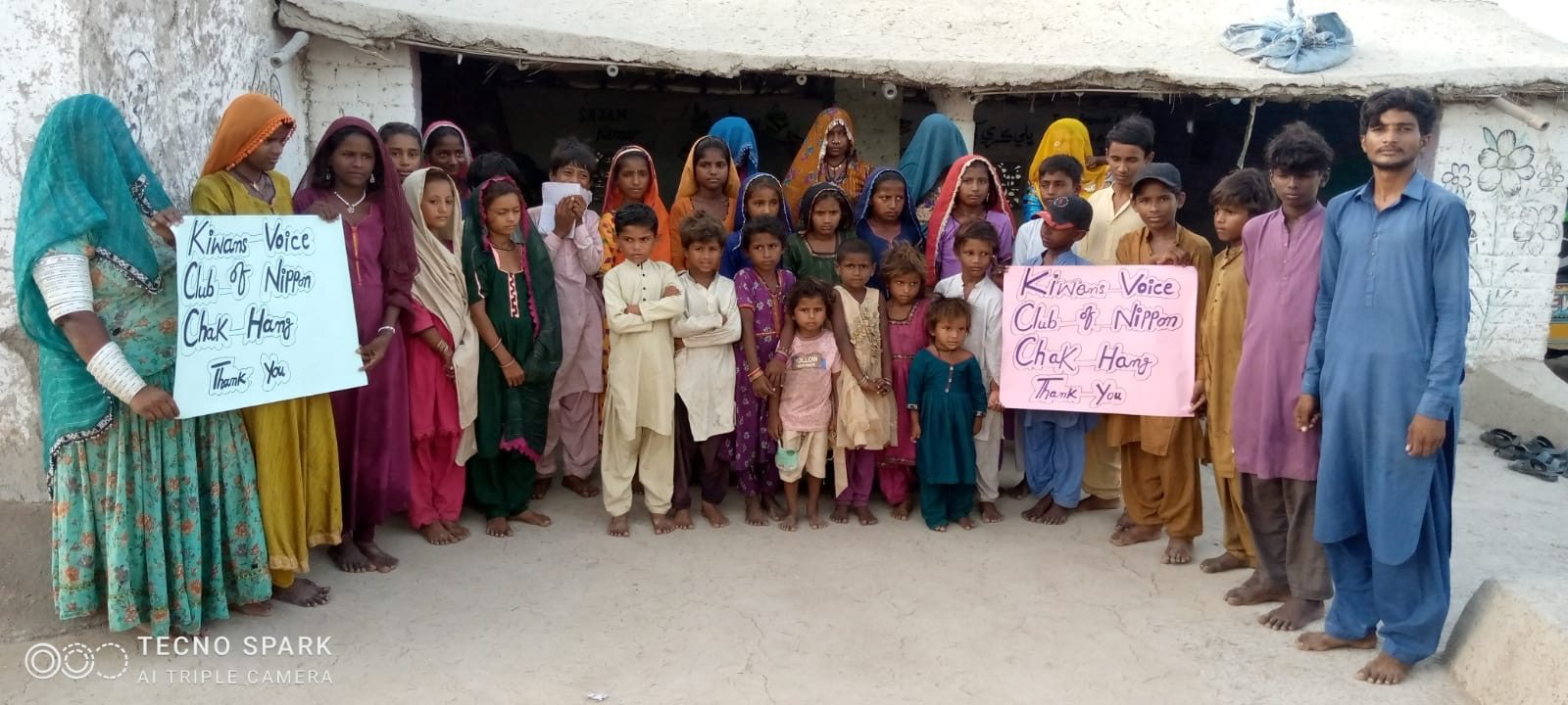 Community holding a thank-you message to the Kiwanis Voices Club of Nippon